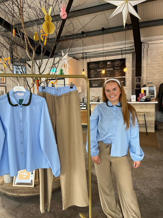 Blue blouse with green trim